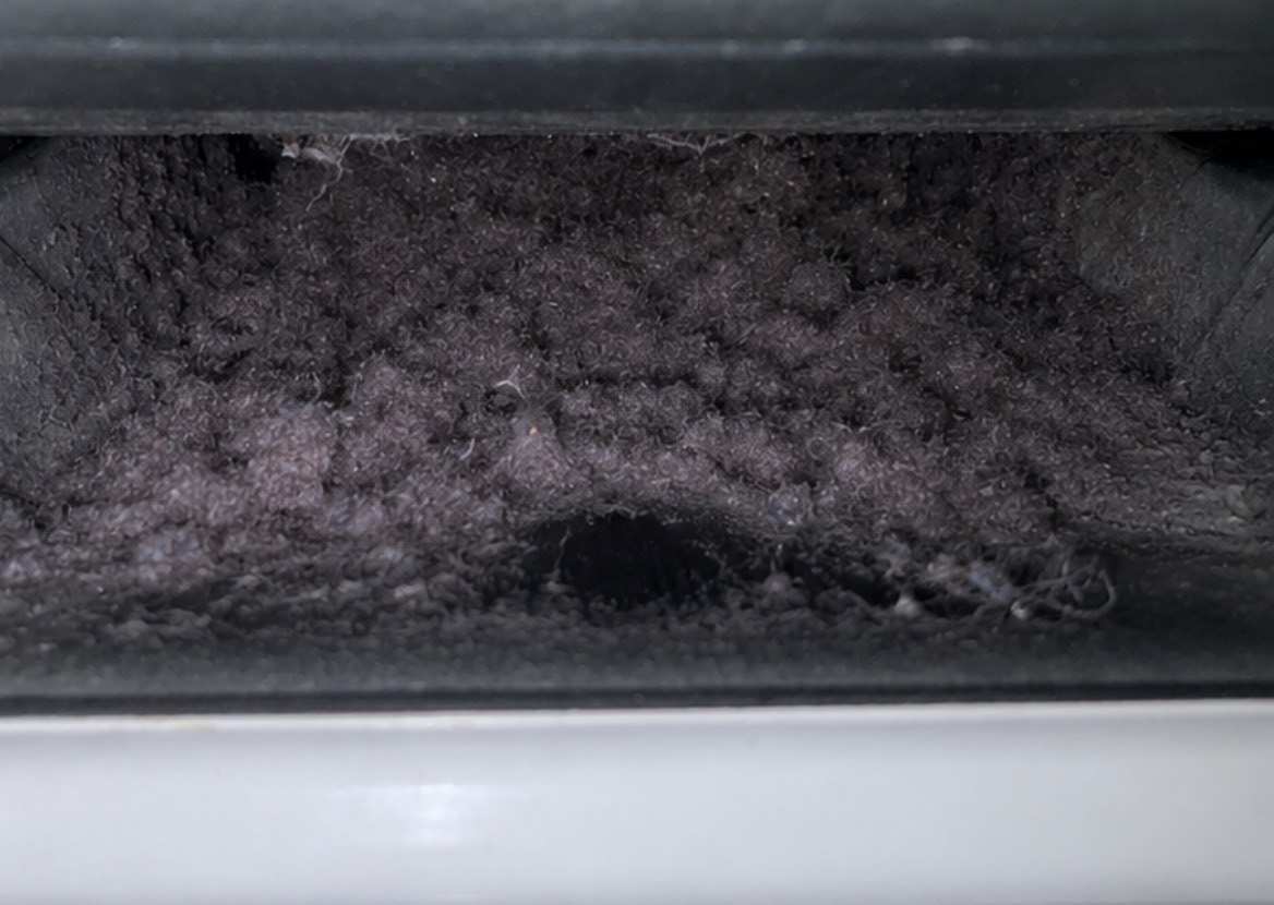 Lint buildup inside a lint screen chute before cleaning
